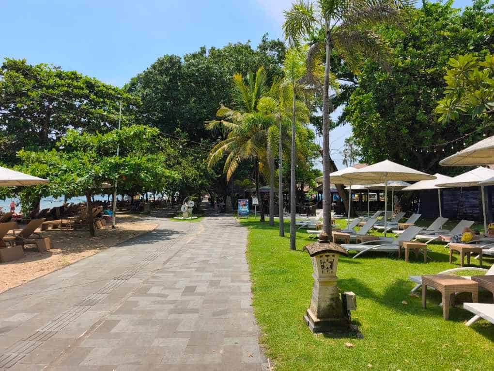 Sanur beach path walkway past Prama resort Bali Indonesia palm trees