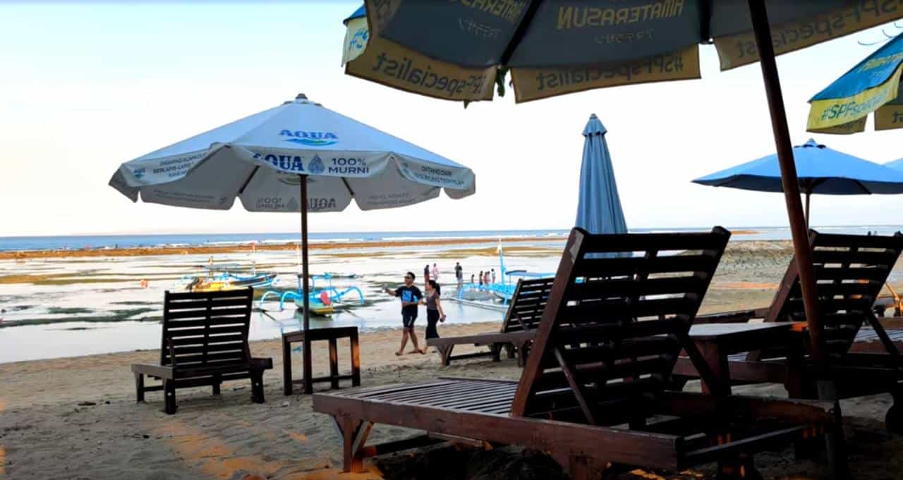 Sun lounges on Sanur Beach Bali Indonesia with calm ocean views