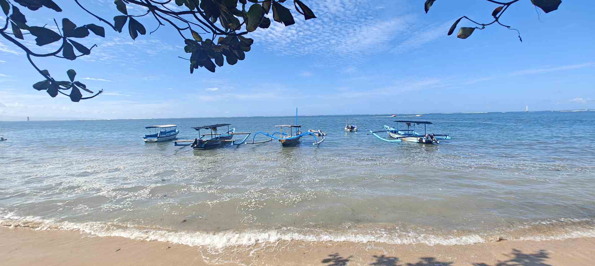Traditional jukung fishing boats on Sanur Beach Bali Indonesia at sunrise