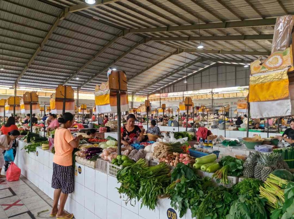 shop keepers tending to their stalls at the Sanur Morning Market in Bali Indonesia